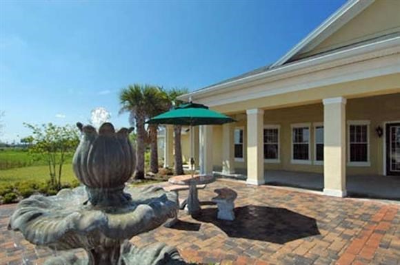 a mansion with a courtyard with a fountain and a building