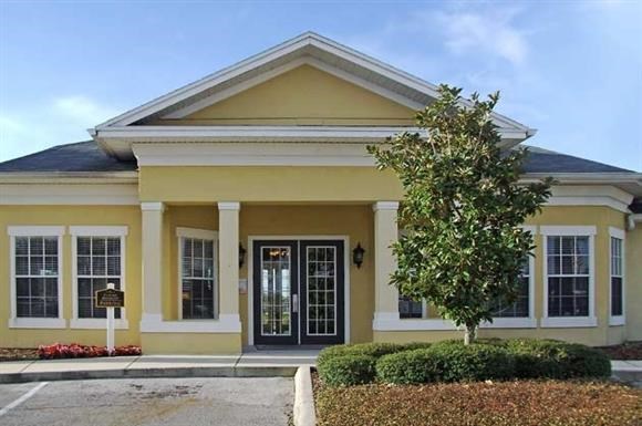 a yellow house with a tree in front of it
