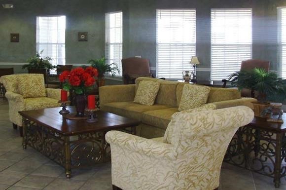 a living room with couches and chairs and a table