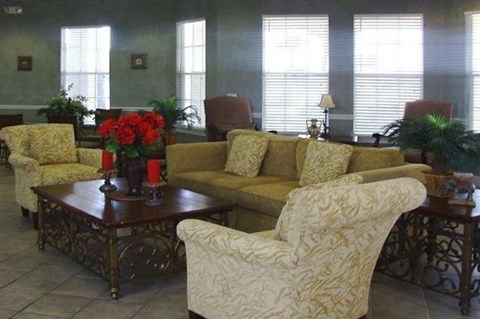 a living room with couches and chairs and a table