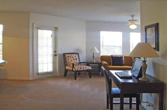 a living room with a laptop computer on a desk
