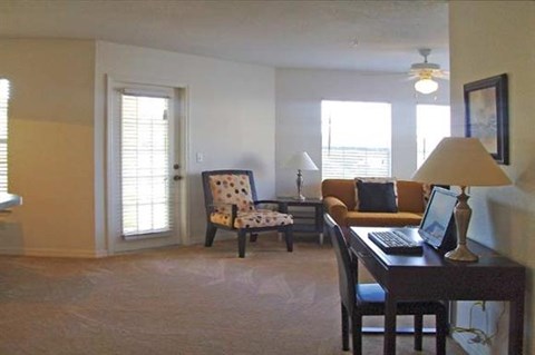 a living room with a laptop computer on a desk
