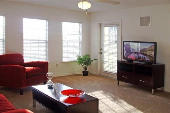 a living room with a red couch and a television