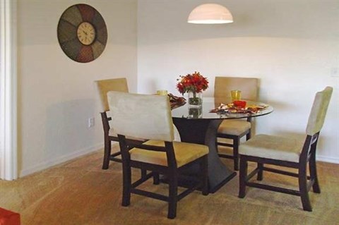 a dining room with a table and chairs