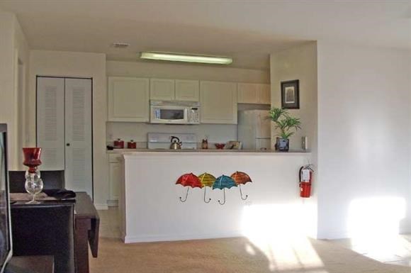 a living room with a counter and a kitchen