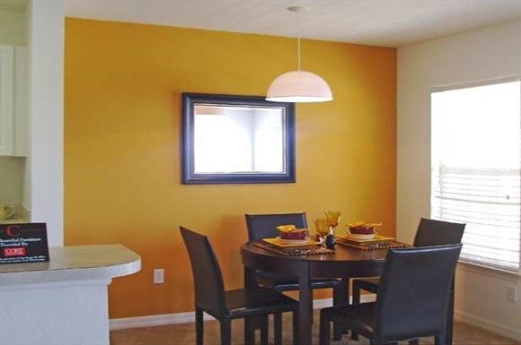 a dining room with a table and chairs
