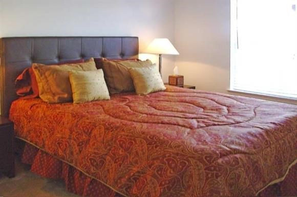 a bedroom with a bed with pillows on it