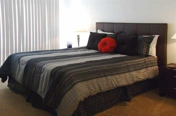 a bed with a blanket and pillows on it