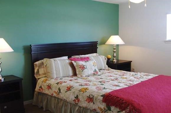 a bedroom with a bed and two lamps