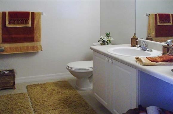 a white bathroom with a toilet and a sink