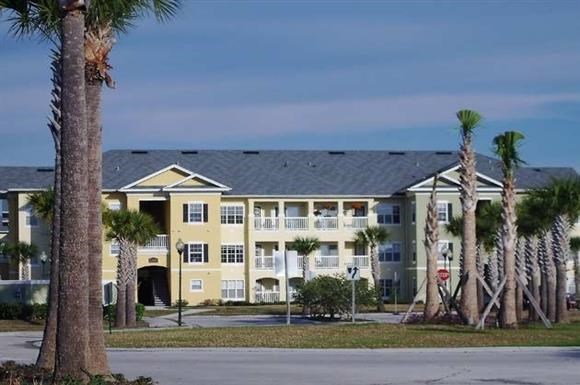 a large building with palm trees in front of it
