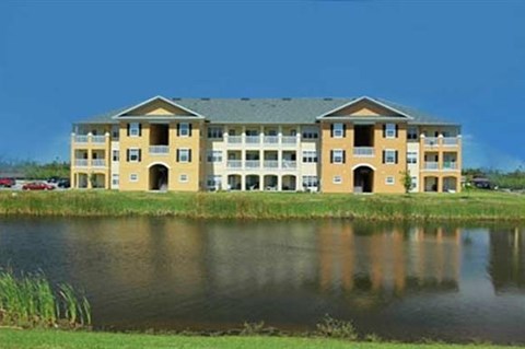 an apartment building next to a body of water