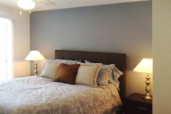 a bedroom with a bed and two lamps