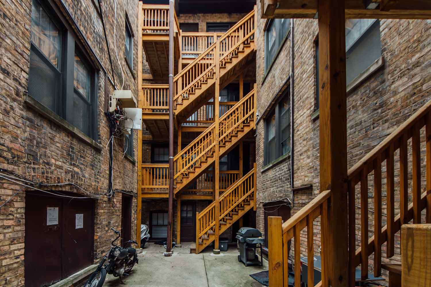 the back of a brick building with wooden stairs
