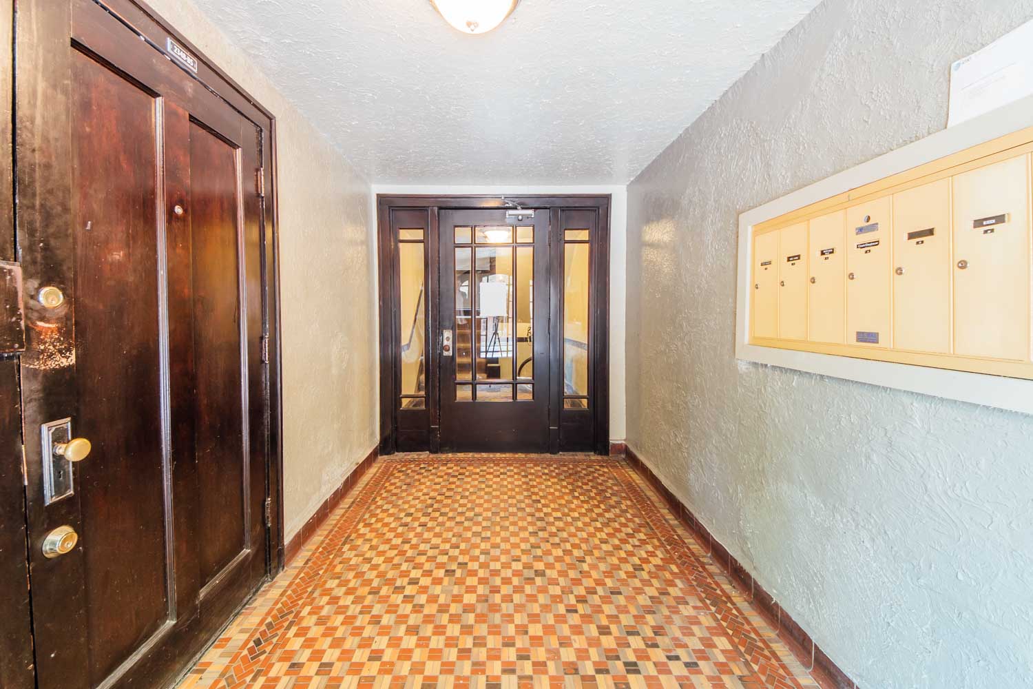 a hallway with a checkered floor and doors
