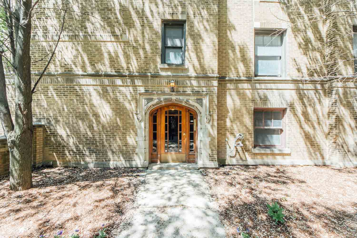 the front of a brick building with a wooden door
