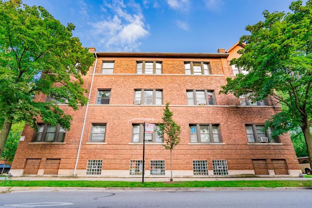 a red brick building with trees in front of it