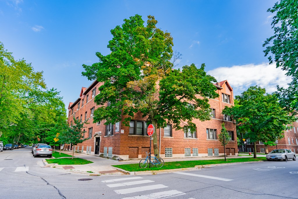 a red brick building on the corner of a city street