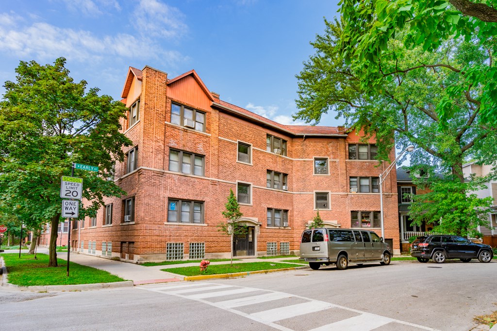 a large brick building with a van parked in front of it