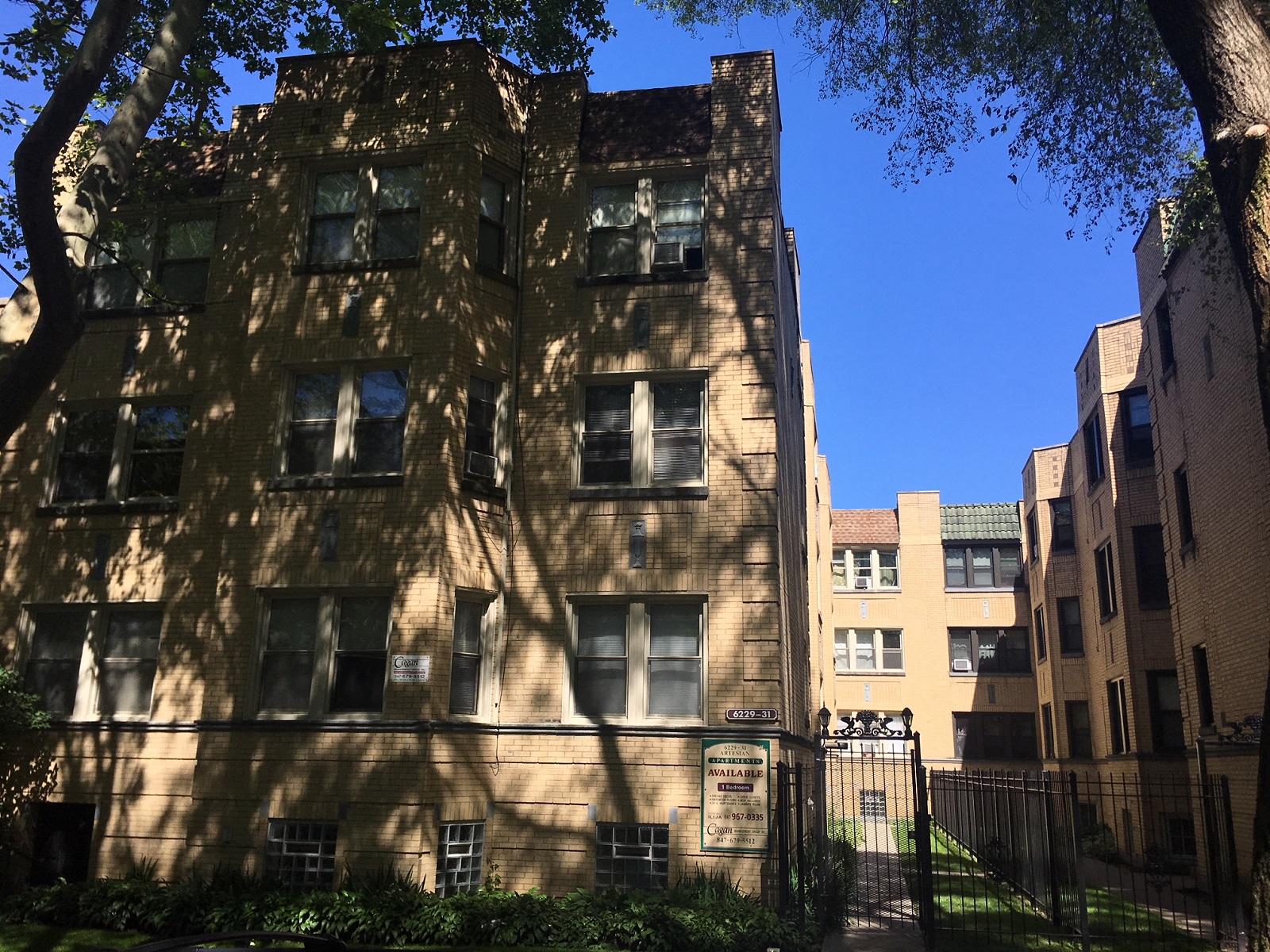 a tall building with a tree in front of it
