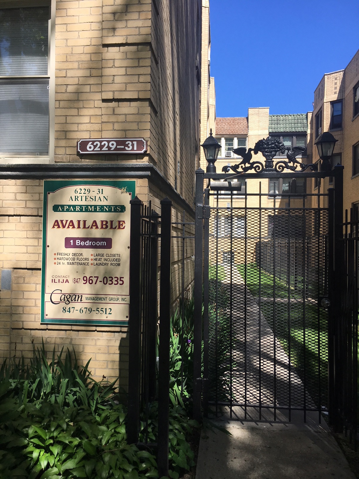 a building with a gate and a sign on the side of it