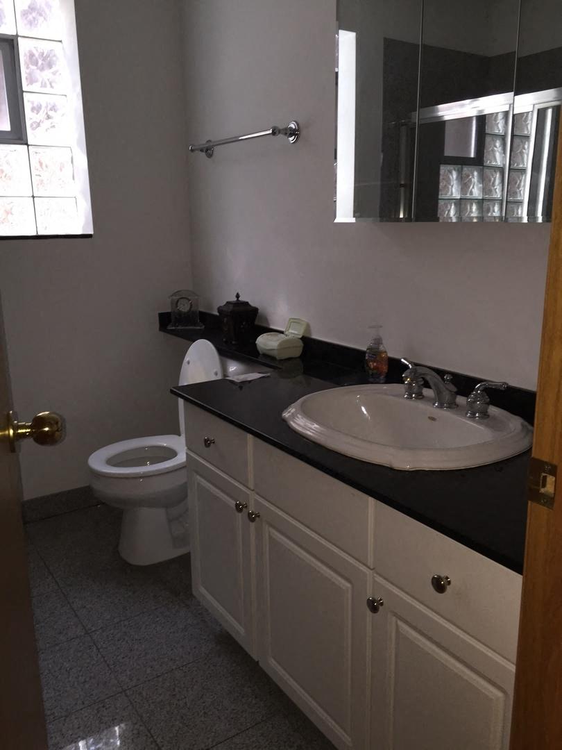 a bathroom with a sink toilet and a mirror