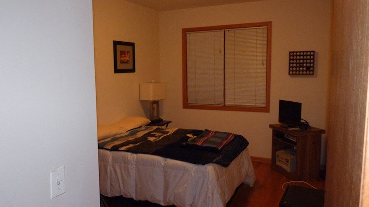 a bedroom with a bed and a window