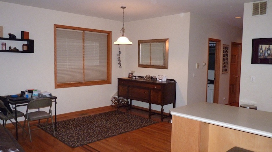 a dining room and living room with a table and a dresser