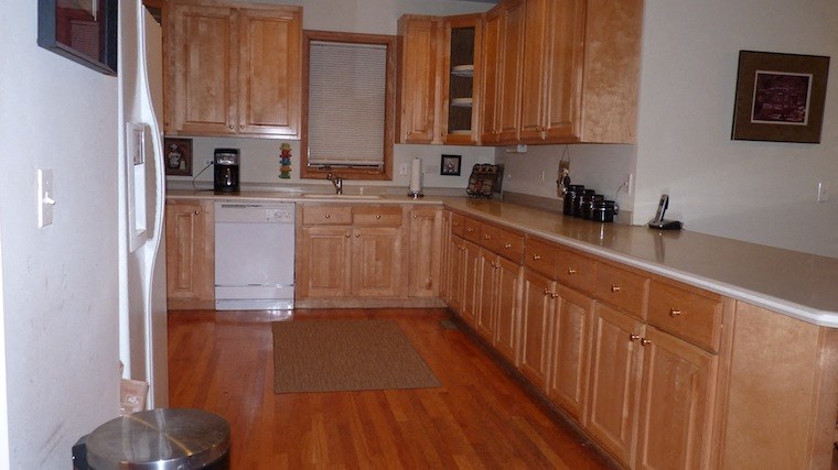a kitchen with wooden cabinets and white appliances