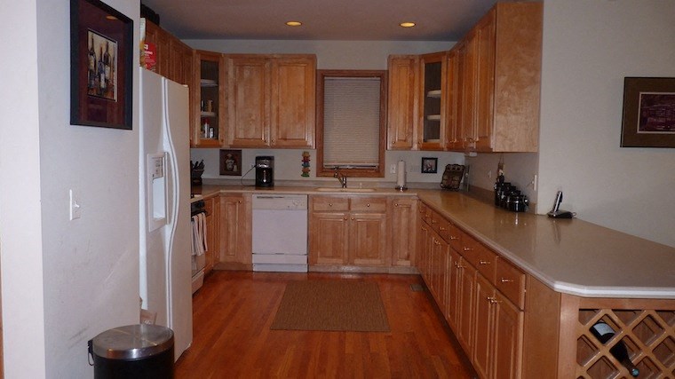a kitchen with wooden cabinets and a white refrigerator