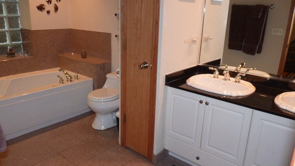 a bathroom with a toilet and a sink and a bath tub