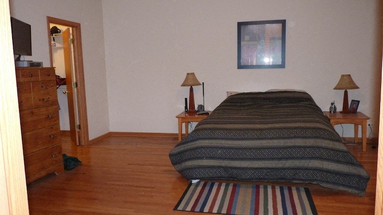 a bedroom with a bed and a dresser