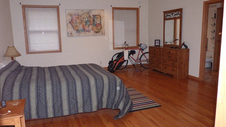 a bedroom with a bed and a bike in it