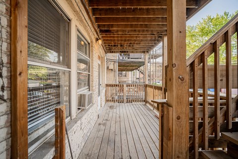 the deck of a house with wooden floors and windows