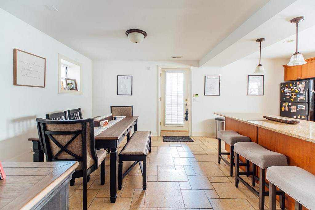 a dining room with tables and chairs and a bar