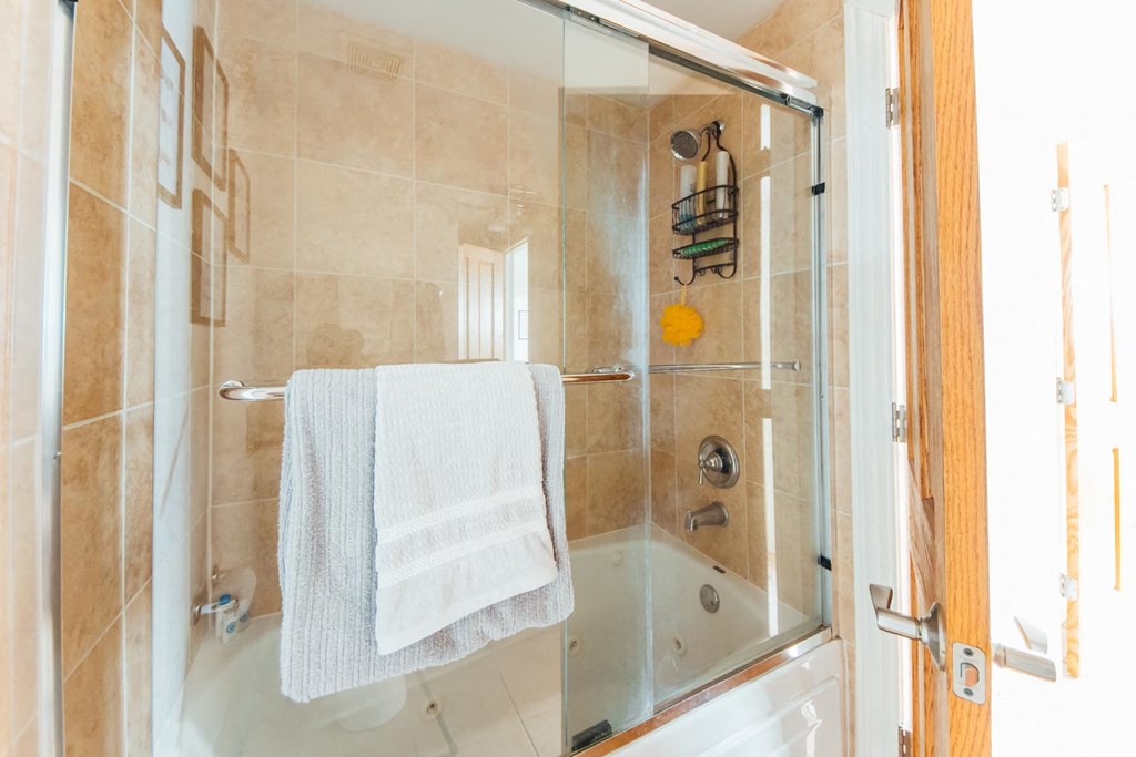 a bathroom with a shower and a towel on a towel rack