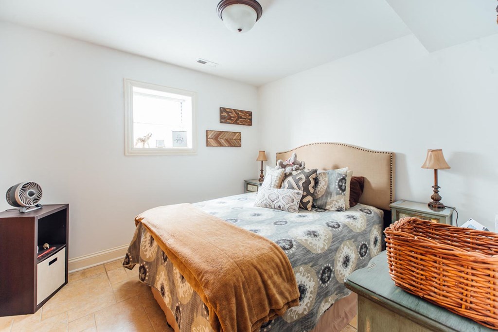 a bedroom with a bed and a window