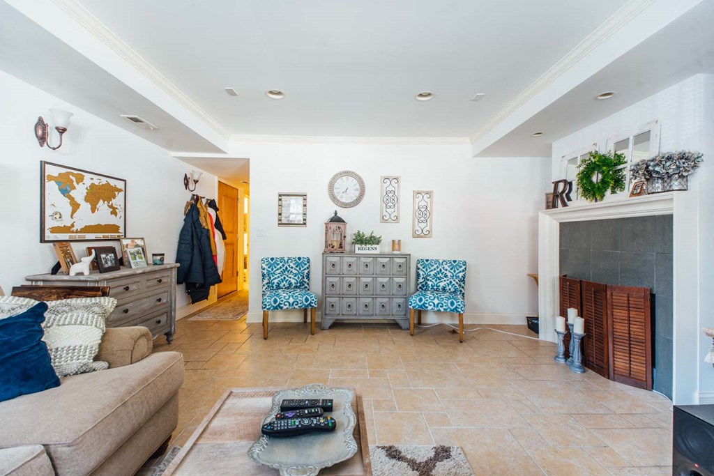 the living room has a fireplace and a dresser