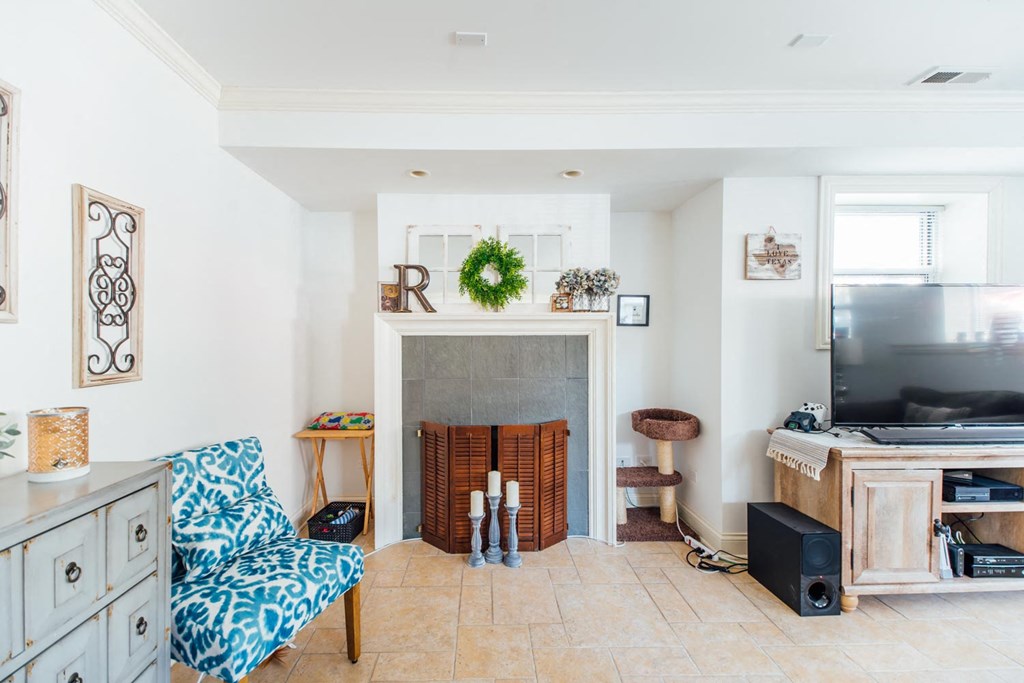 a living room with a fireplace and a tv