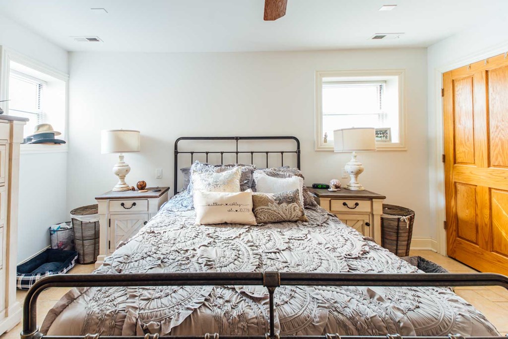 a bedroom with a bed and a wooden closet