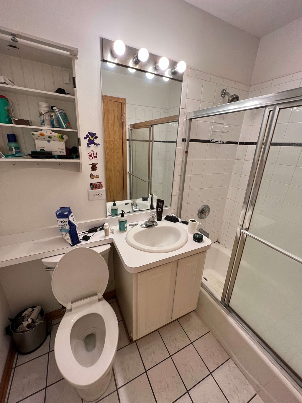 a small bathroom with a sink toilet and shower