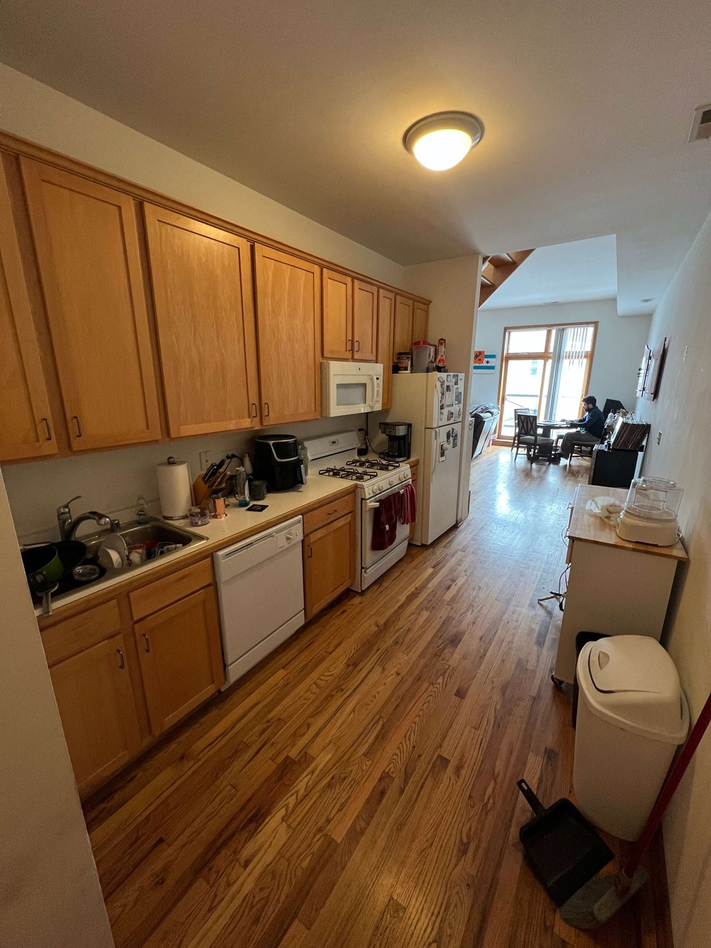 a kitchen with wood floors and wooden cabinets