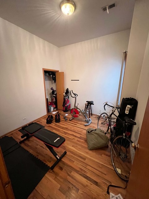 a home gym with a lot of bikes and equipment in it