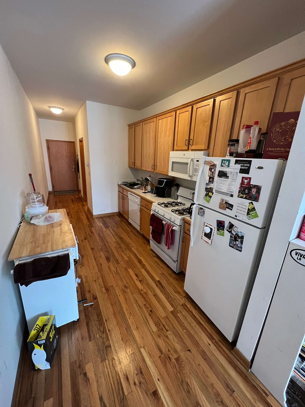 a kitchen with a refrigerator and a stove and a table