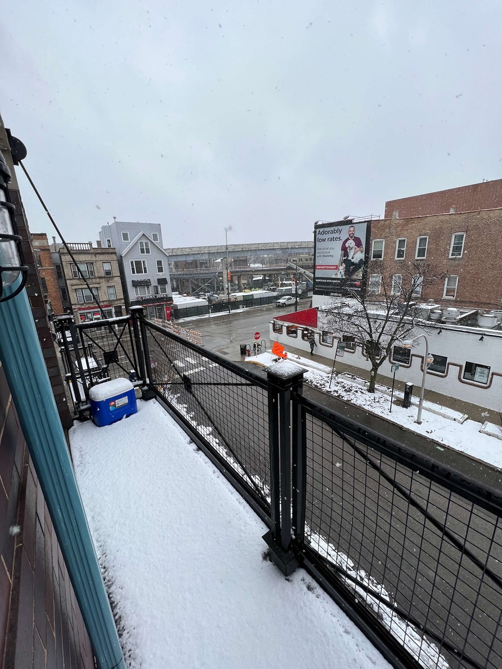 a balcony with a view of a city in the snow