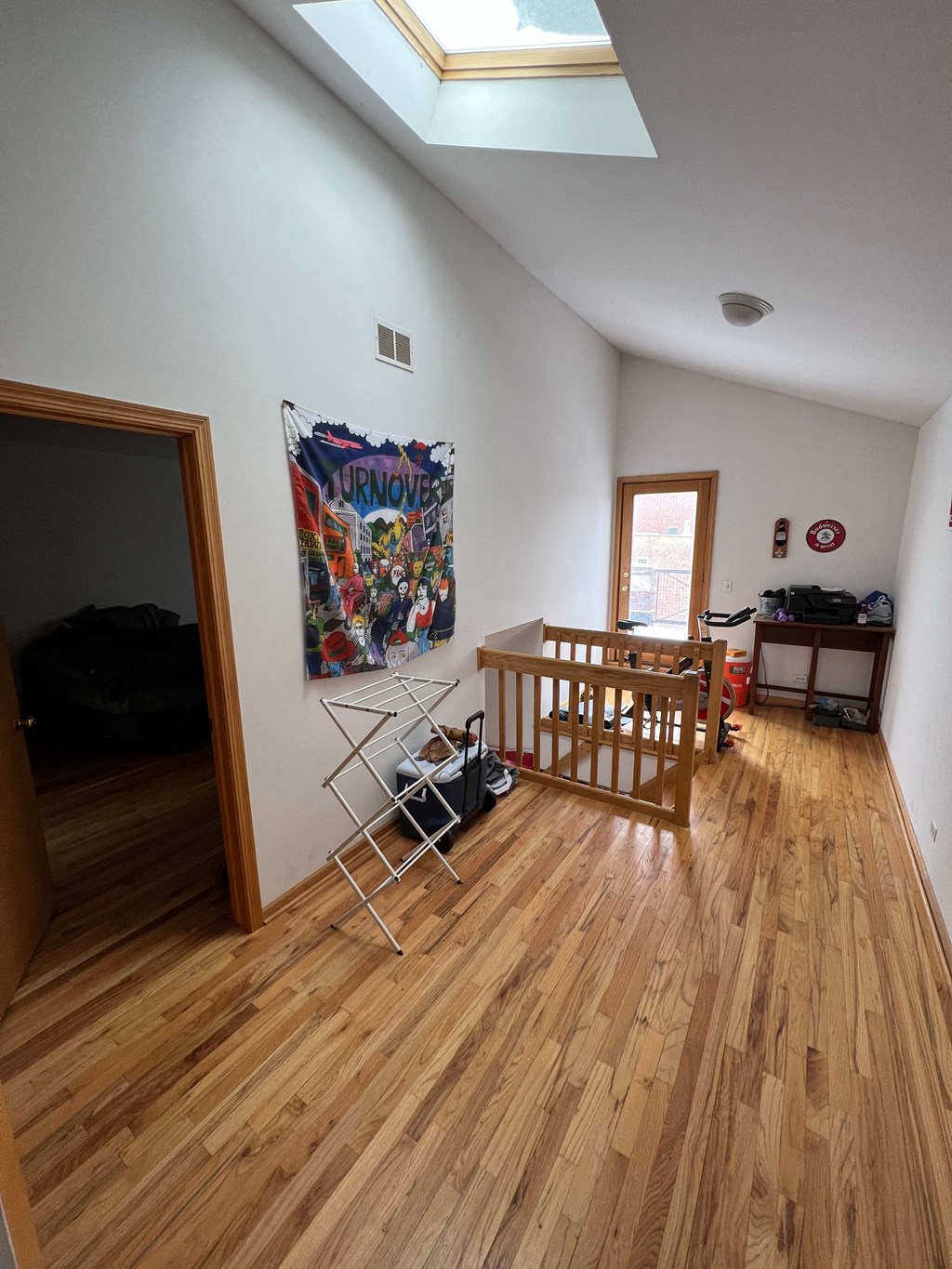 a view of a living room with a wooden floor and a staircase