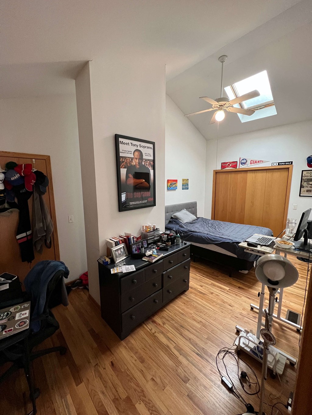 a bedroom with a bed and a ceiling fan