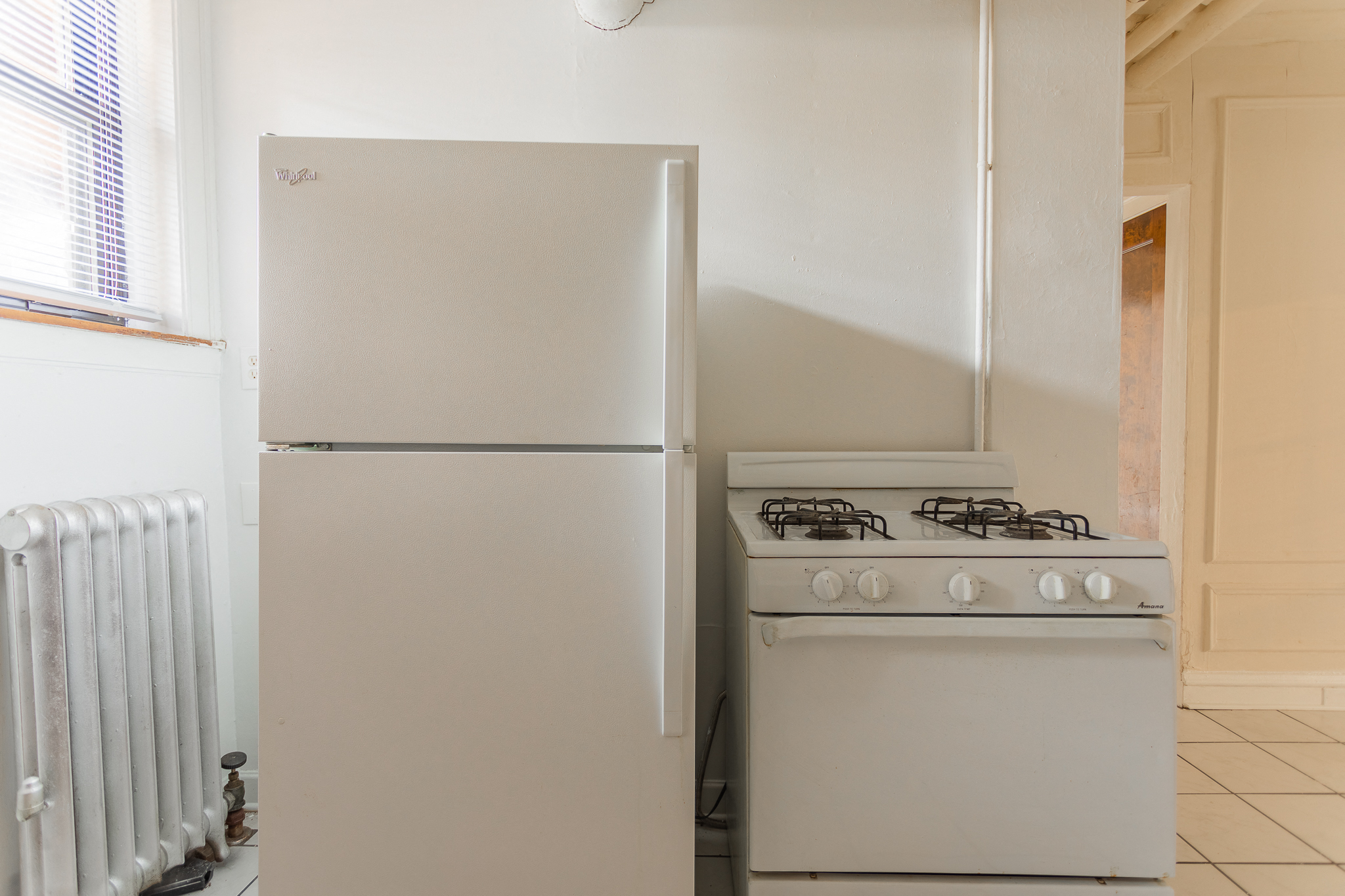 a kitchen with a stove and a refrigerator