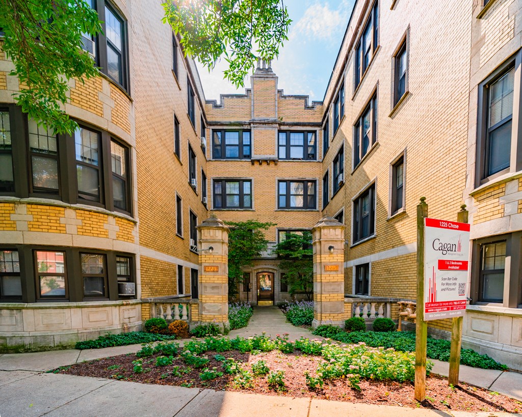 an apartment building with a street sign in front of it
