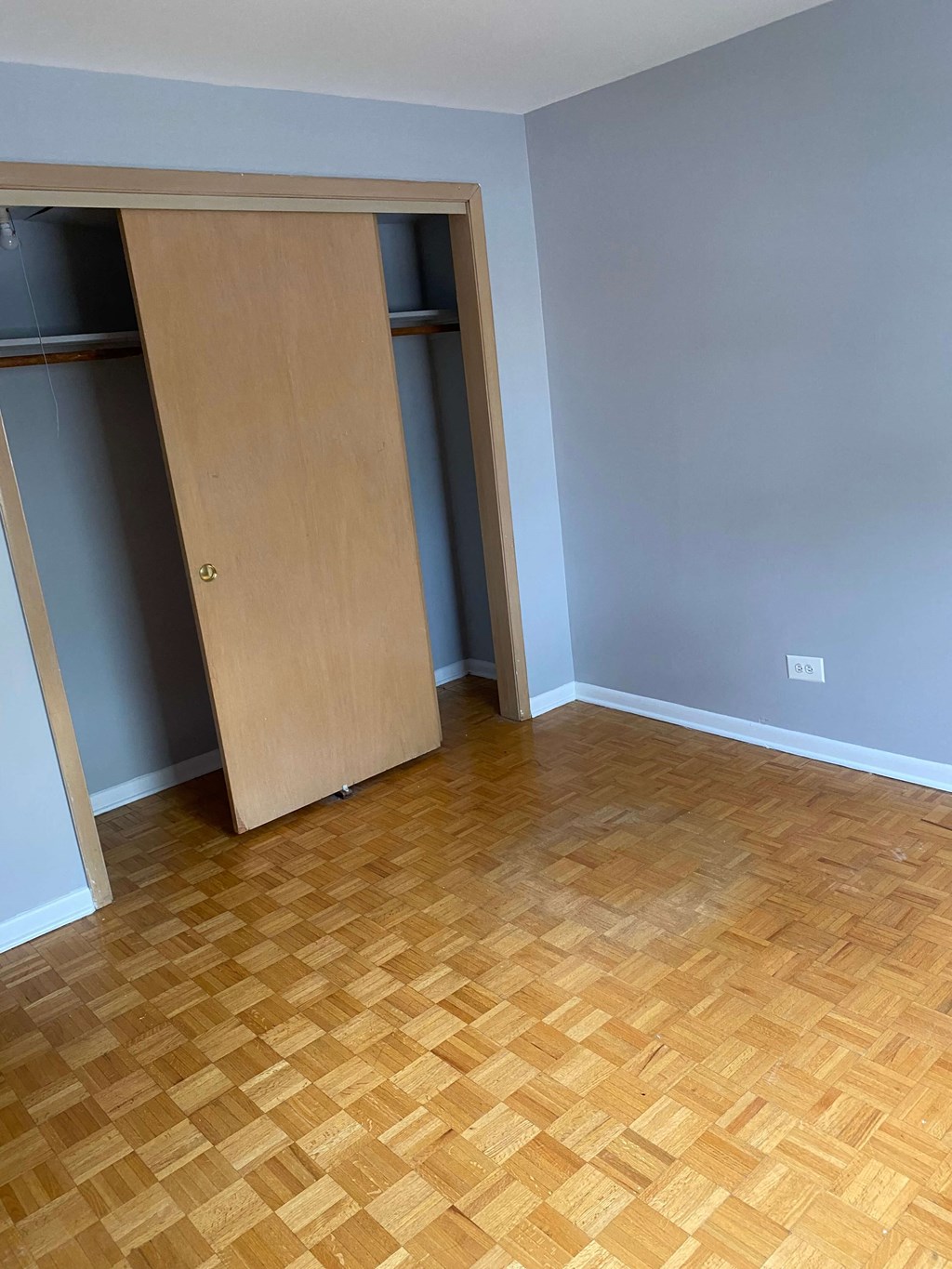 a room with a wooden floor and an open door